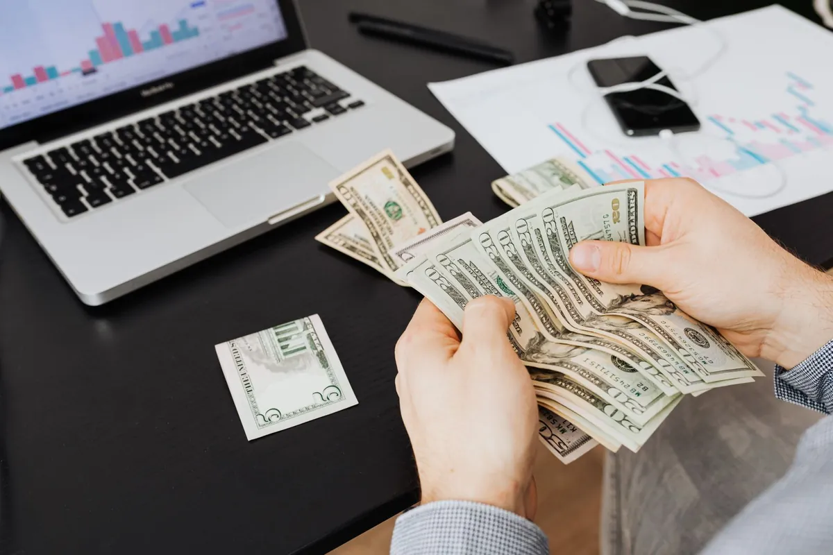 dollar bills with rising chart line